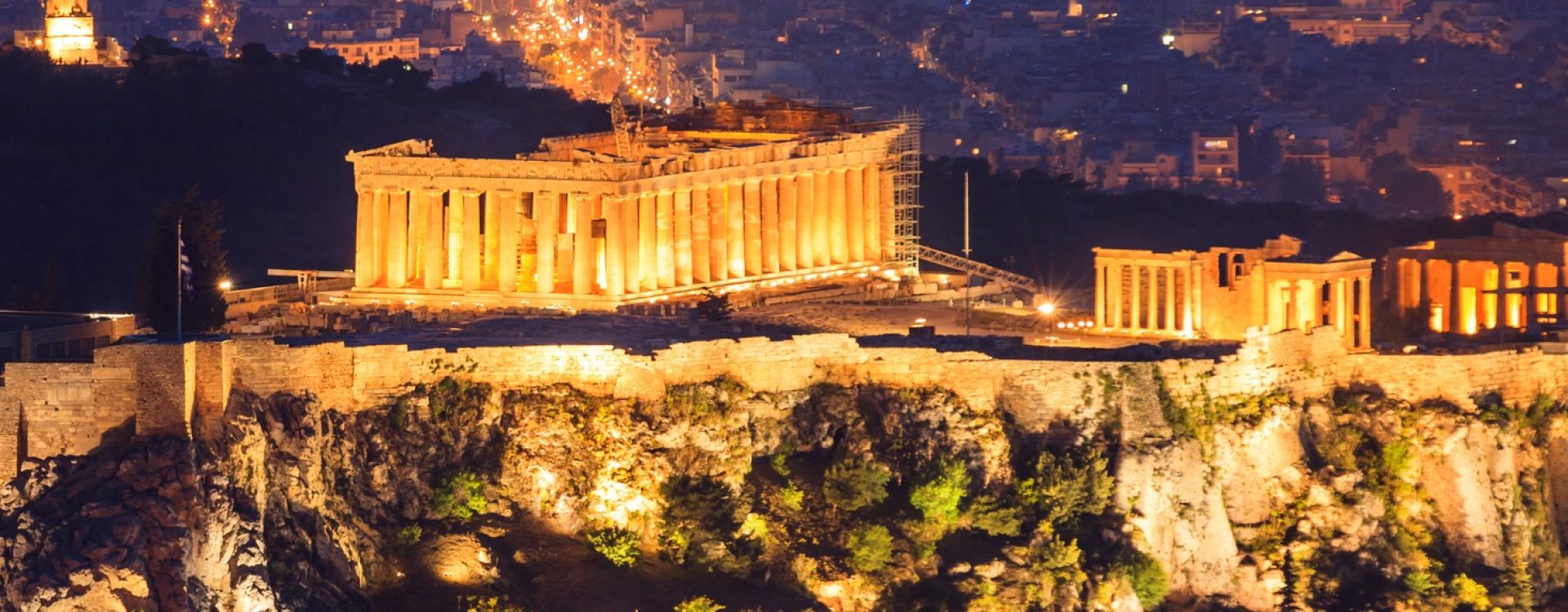 Vertical view of illuminated Acropolis of Athens. Greece at night background.