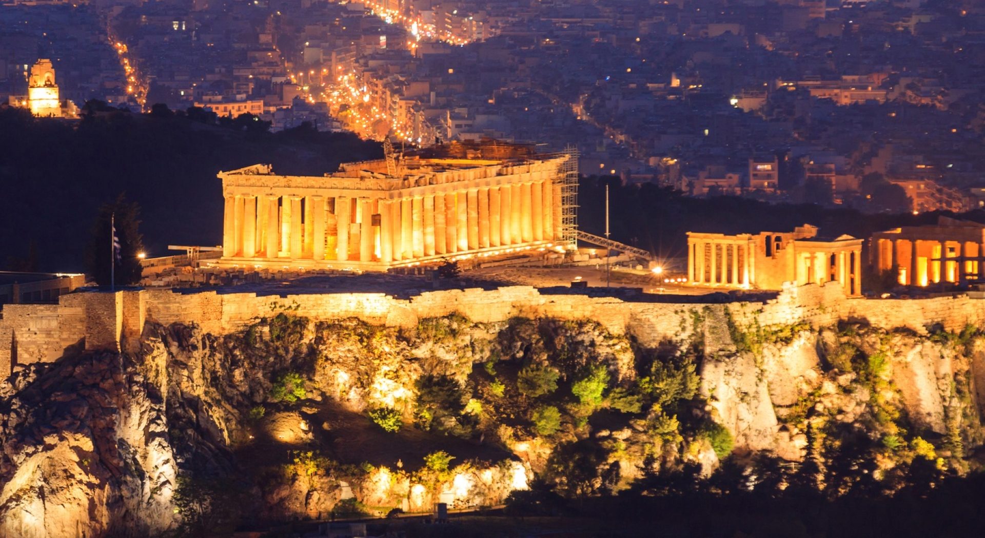 Vertical view of illuminated Acropolis of Athens. Greece at night background.